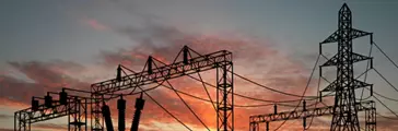 Electrical transformers against an orange sky. / Dreamstime Image #5172361