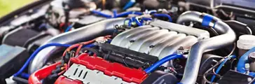Close-up photo of modern turbocharged motor with pipe.