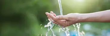 Water pouring in someone’s hand.