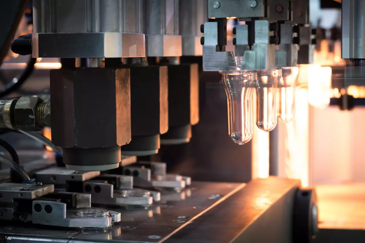 Plastic bottle making process in factory.