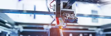 Three dimensional printing machine printing out an object.